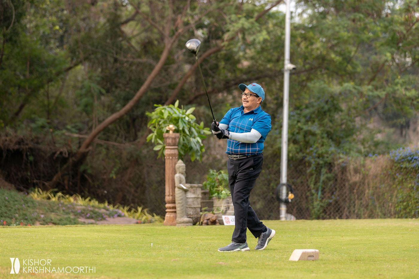 A golfer mid-swing on the tee