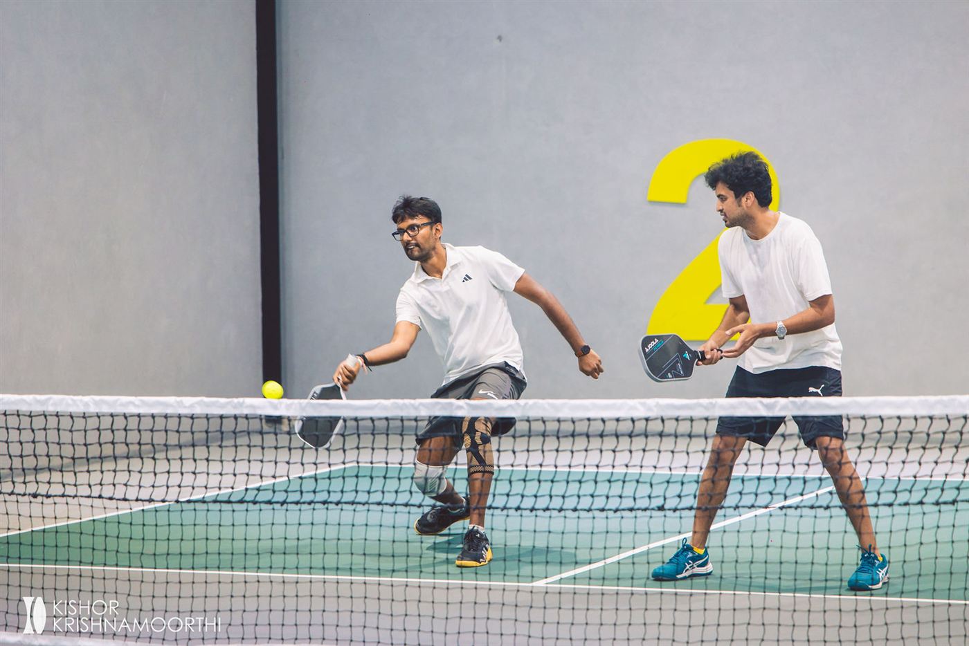 A doubles pair at the net during the pickleball tournament